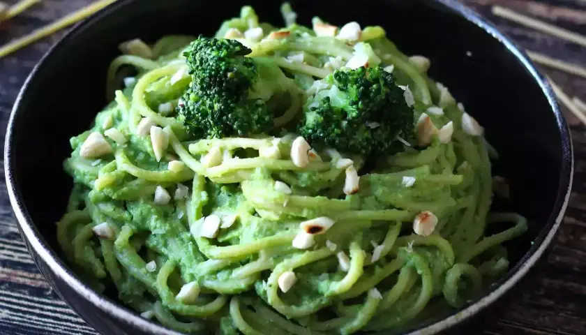 Deliciosa pasta con brócoli cremoso y trocitos de frutos secos, un plato vibrante y nutritivo.
